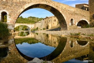 Bild på Reflection and symmetry with a medieval bridge in Lagrasse